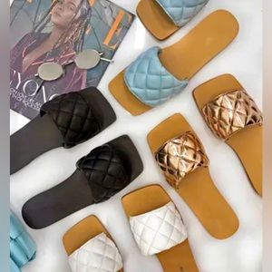 Women’s luxury sandals/slides. Also know as flip flops or flats.